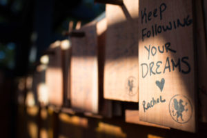 The shingles are each stamped with one of several patterns, and visitors are encourage to write their wish down on and hang it on one of the pegs lining the inside of the tea house.